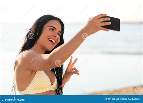 smiling woman in bikini taking selfie on beach stock image image of person photographing