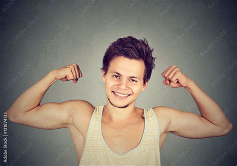 Fit And Muscular Young Man Flexing His Biceps Stock Photo Adobe Stock