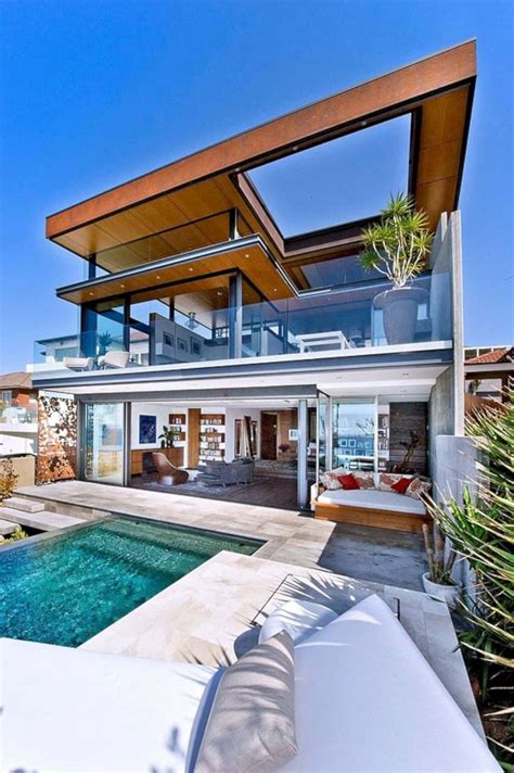 A House With A Swimming Pool In Front Of It And An Ocean View From The