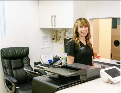 Warm and friendly front desk staff at Coral Springs dentist Wisdom
