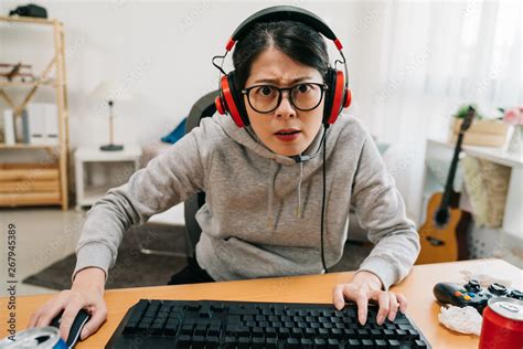 Young Woman Nerd High School Student Playing Computer Game In Headsets