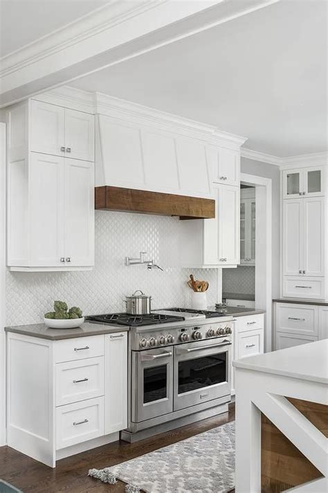 Cottage Style Range Hood Features A Wood Trim Above A Swing Arm Pot