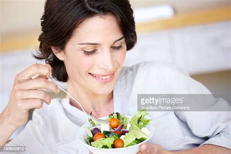 mature woman eating salad photos and premium high res pictures getty images