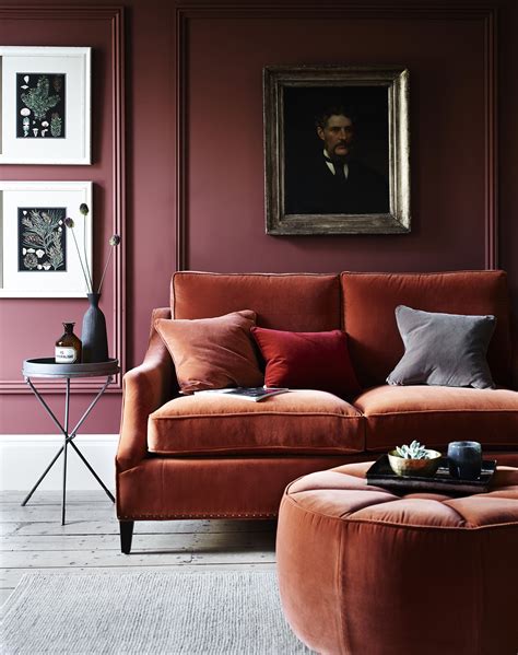 Dark Orange Velvet Sofa In A Living Room With Dark Red Walls Interior