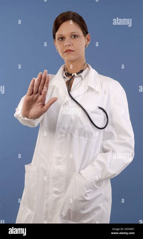 Young Female Doctor With Stethoscope Showing Stop Hand Gesture Stock