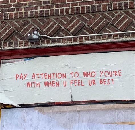 A Sign On The Side Of A Building That Says Pay Attention To Who Youre