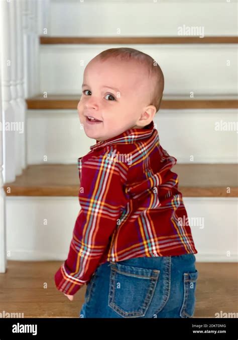 Portrait Of Cute Baby Boy Standing On Steps At Home Stock Photo Alamy