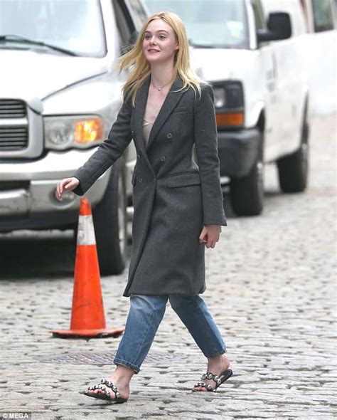 Elle Fanning Flashes Her Midriff While Posing Up A Storm On Streets Of