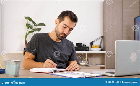 Man Writing On Notebook At His Desk Stock Photo Image Of Modern