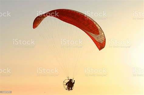 Red Parachute Flying At Sunset Stock Photo Download Image Now