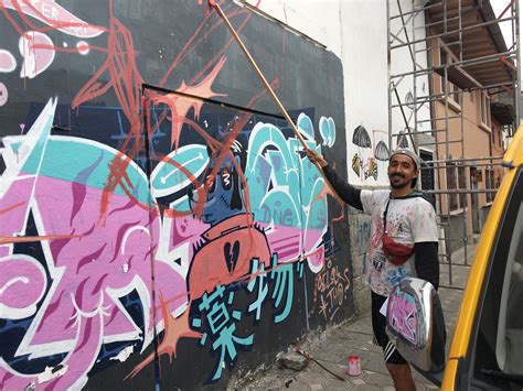 The Artist Mirasarte Redoing A Street Art Mural In Cuenca Ecuador Day