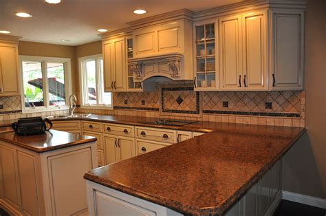 A cream and jute fringe runner sits in front of white shaker kitchen cabinets adorned with oil rubbed bronze pulls and a black leathered granite countertop. Cream cabinetry, tile backsplash, Laminate top (With images) | Kitchen, Tile backsplash, Kitchen ...