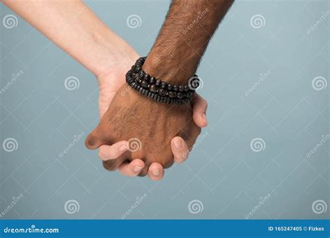 Close Up African American Man And Caucasian Woman Holding Hands Stock