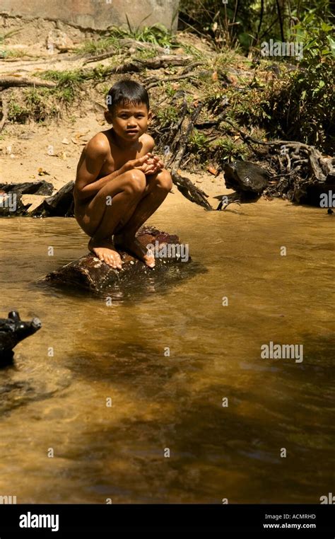 Naked Cambodian Boy Squatting On The Stone Stock Photo Alamy