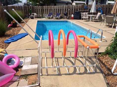 When you're finished swimming for the day, throw all the pool toys in the net. Nailed it! Poolside storage for rafts, toys, goggles ...