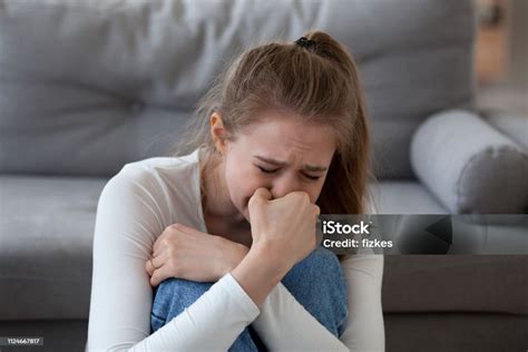 Desperate Upset Teen Girl Victim Crying Alone At Home Stock Photo