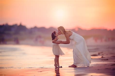 Mother And Daughter Kissing At Sunset On The Beach Stock Image Image