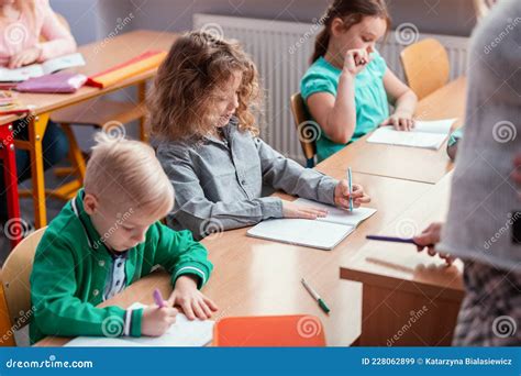 Children Sit At The Tables In The Classroom Stock Image Image Of