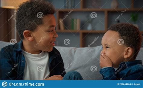 Two Little Boys Friendly Talking Laughing At Home Ethnic African