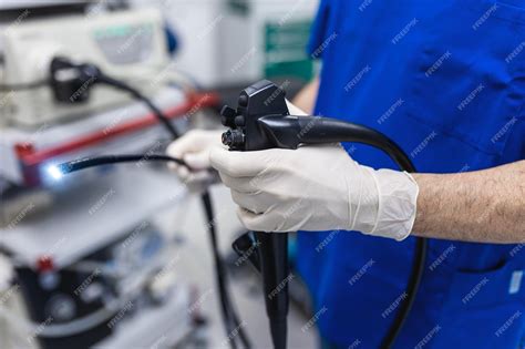 Premium Photo Doctor Proctologist Holding Endoscope During