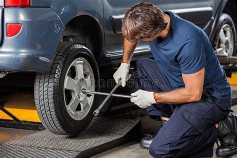Mechanic Fixing Car Tire Stock Image Image Of Person 61544203
