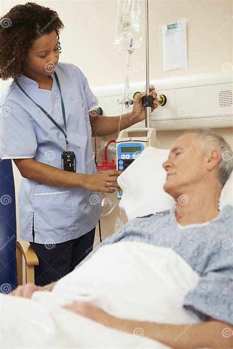 Nurse Adjusting Male Patient S Iv Drip In Hospital Stock Photo Image
