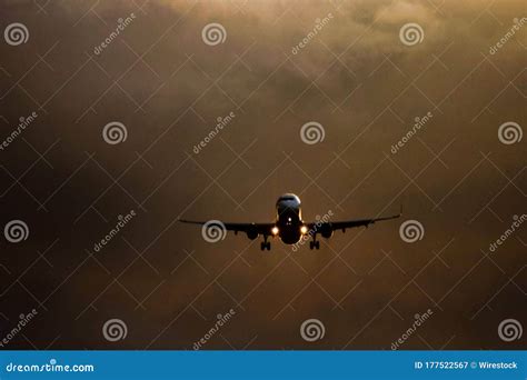 Airplane Descending From The Clouds With Two Lights On Stock Image