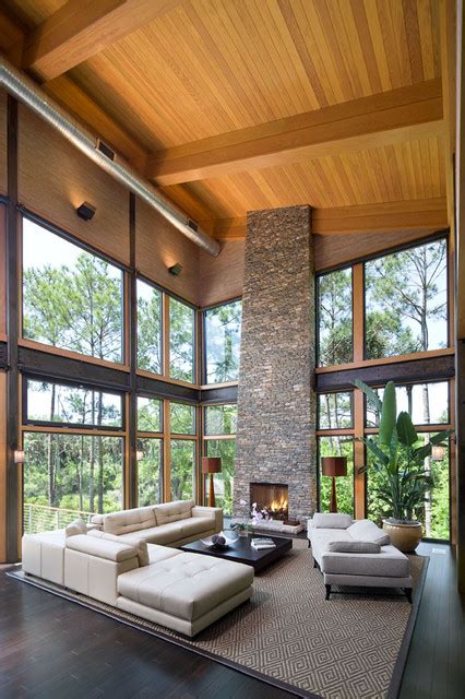The living room is considered the main room in the house because it is a place that combines all the family at all times. Large glass area focuses view to lagoon. - Contemporary - Living Room - Charleston - by ...