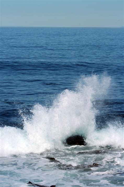 A Wave Crashing Against A Rock In The Pacific Ocean Stock Image Image