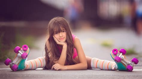 Cute Little Girl Skater Is Sitting On Road Holding Face In
