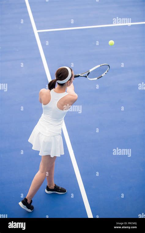 Woman Serving Ball In Tennis Court Stock Photo Alamy