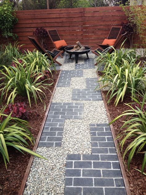 Natural stone edge to add texture and flow. Tetris inspired pathway with grey brick and gravel ...