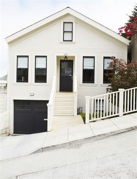 Maybe you would like to learn more about one of these? White exterior with black trim windows, a black front door ...