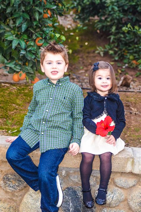 Brother and sister playing with each other outside. Brother and little sister • Tilden Photography