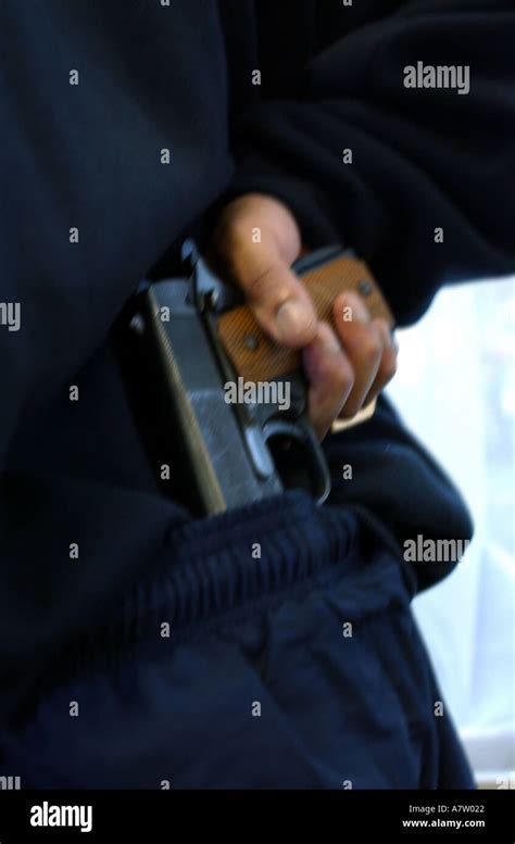 A Gang Member Holding A Colt Automatic Pistol Gun Stock Photo Alamy