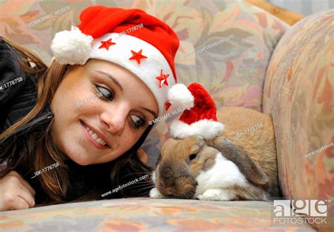 Young Woman With A Dwarf Lop Bunny Or Rabbit Oryctolagus Cuniculus