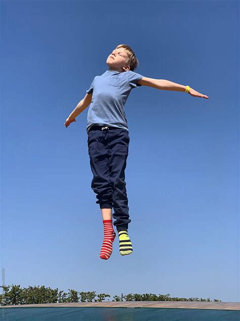 Child Jumping In The Air By Stocksy Contributor Sally Anscombe