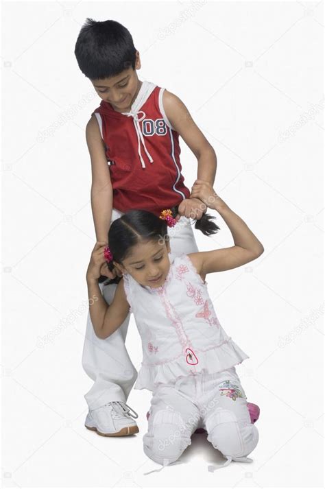 Boy Pulling Hair Of His Sister — Stock Photo © Imagedbseller 32970841