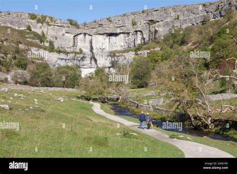 Two People Walk Along The Footpath To Malham Cove In The Yorkshire