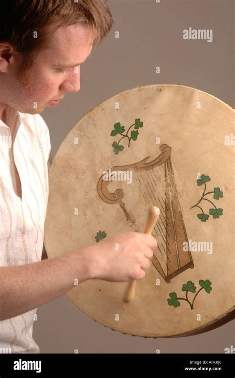 Welsh Folk Music Man Playing Bodhrán Drum With A Celtic Harp Design