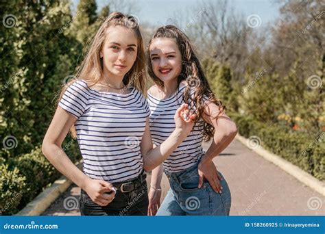 Two Smiling Young Female Girl Friends Having Fun In Park Two Teen