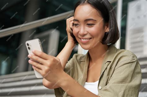 Premium Photo Portrait Of Asian Girl Takes Selfie On Mobile Phone Korean Woman Smiling Video