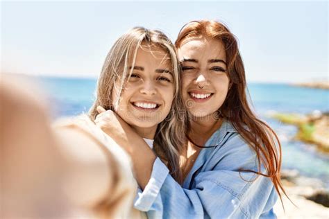 Young Lesbian Couple Of Two Women In Love At The Beach Stock Image