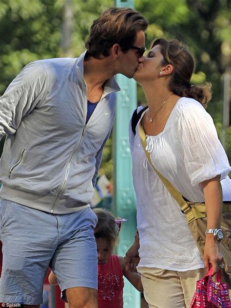 Both professional tennis players they met back in 2000 and married nine years later. Roger Federer puckers up to his wife as they stroll around ...