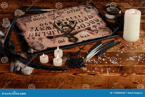Ouija Board With Candles Seance On Wooden Table The Mystical