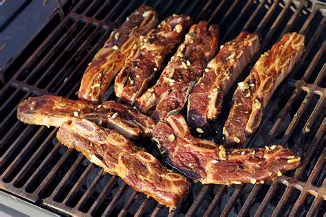 Smoking ribs on a gas grill is a challenge, but we love a good challenge, so read on for our step by step guide. barbecued short ribs grill