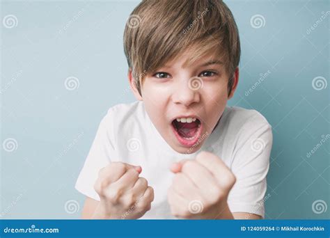 Boy Screams And Jokingly Threatens With His Fists Stock Photo Image