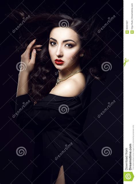 glam dark haired model with beautiful make up and smooth hair wearing black pillbox hat leather