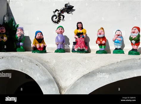 Snow White And The 7 Dwarfs Garden Gnomes Against A White Wall