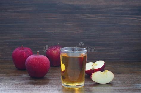 Apple Juice In A Glass And The Ripe Fruit Of Red Apples Stock Photo